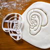 hearing aid cookie cutter pressed on white fondant