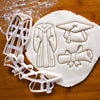 set of 3 graduation themed cookie cutters, featuring a graduation gown, a graduate cap and a scroll