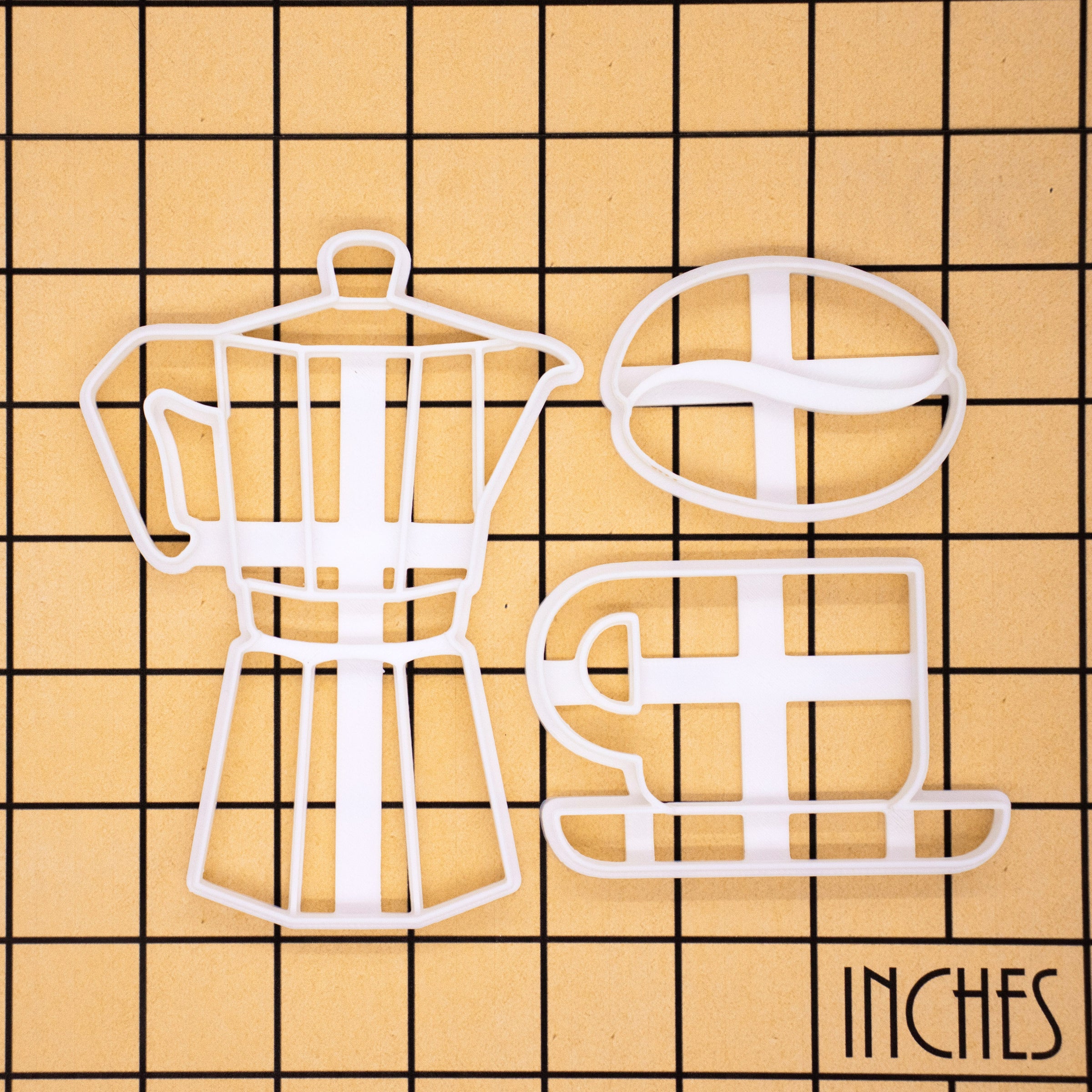 set of 3 coffee themed cookie cutters, featuring a moka pot, coffee bean and coffee cup cookie cutters