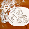Set of construction themed cookie cutters, including a safety helmet, a dump truck and a dig in signage