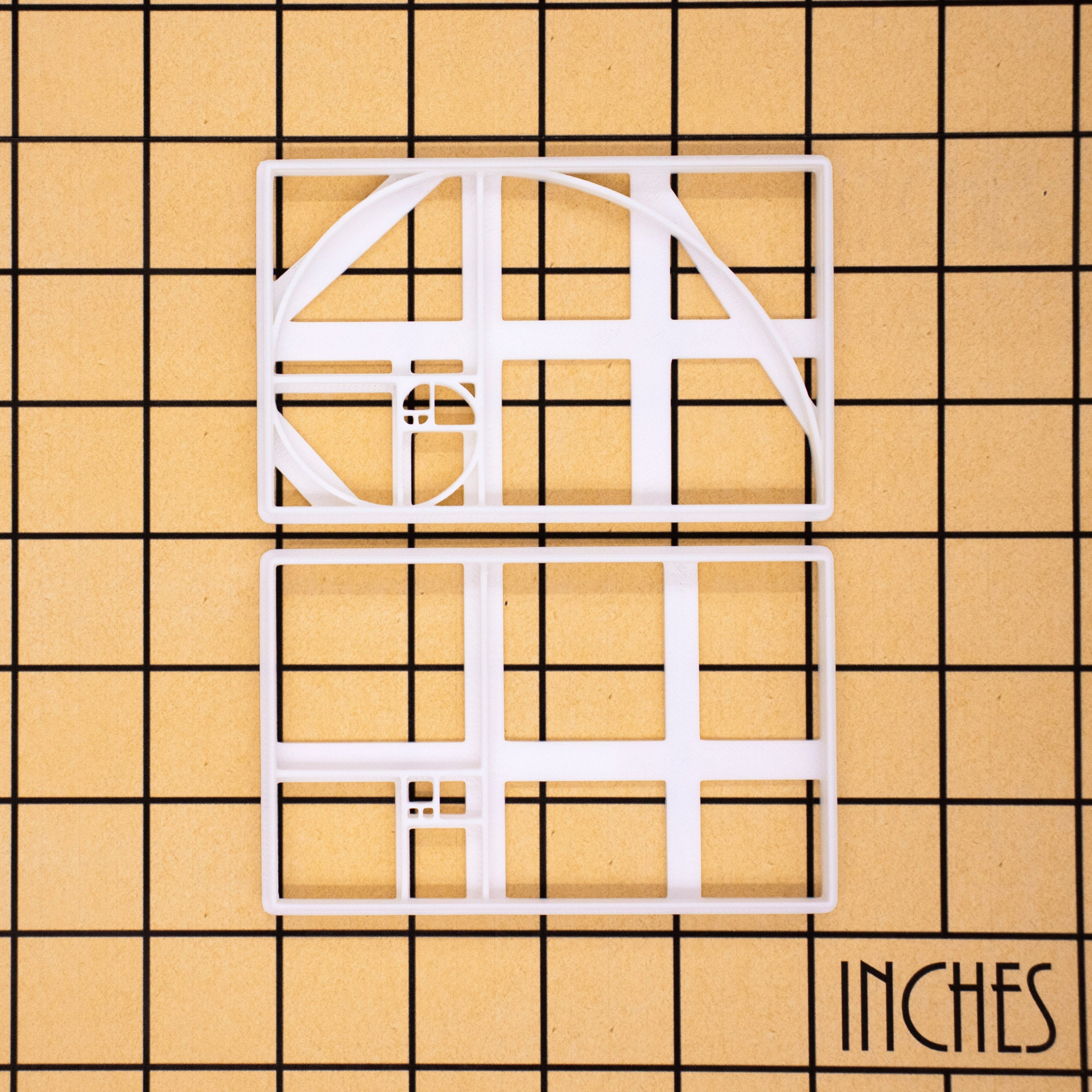 set of 2 golden ratio cookie cutters, featuring a fibonacci spiral and fibonacci tiling
