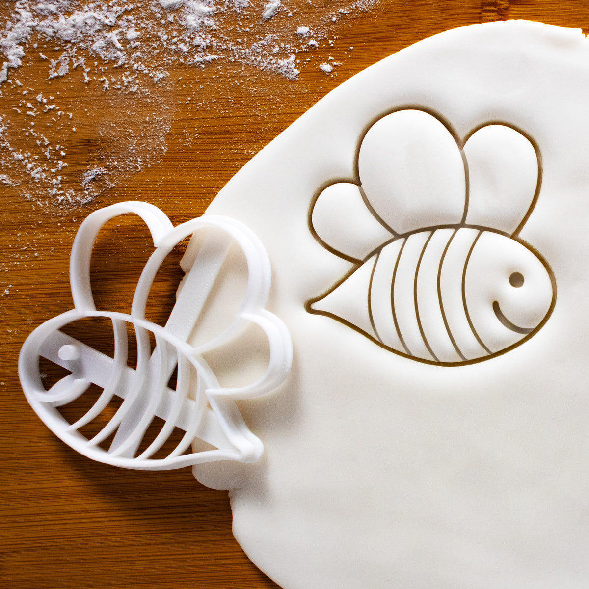cute bee cookie cutter pressed on white fondant, perfect for baby shower