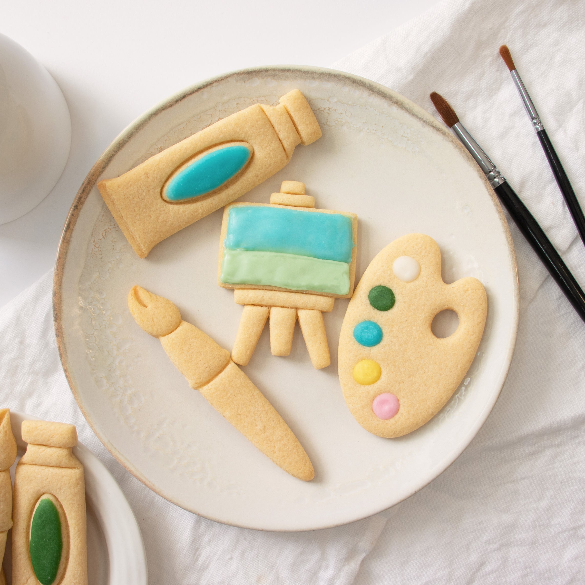 set of 4 artist accessories: featuring a palette, paintbrush, paint tube and easel stand cookies
