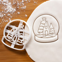 Snow globe cookie cutter pressed on white fondant