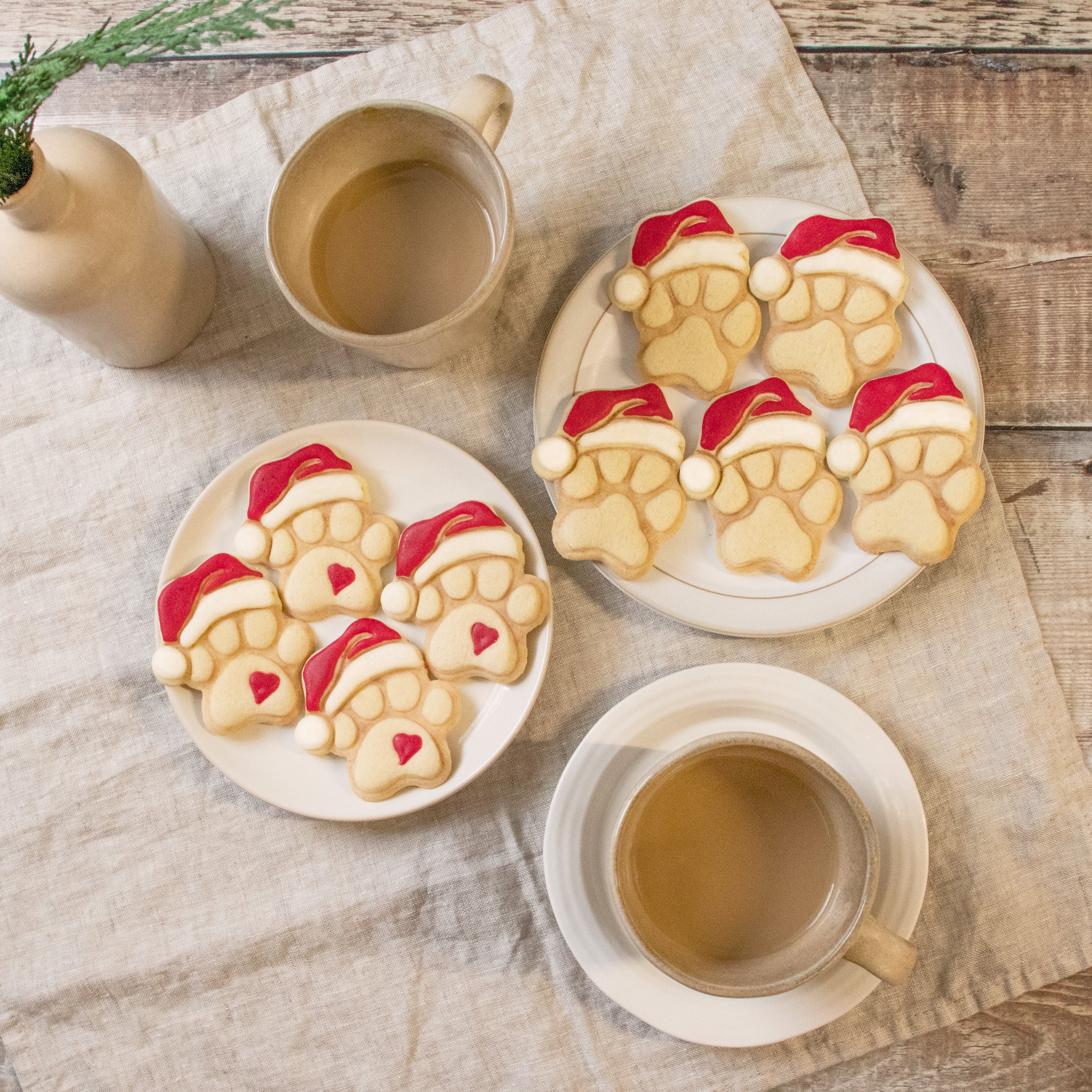 set of cute and realistic christmas dog paw with santa hat cookies